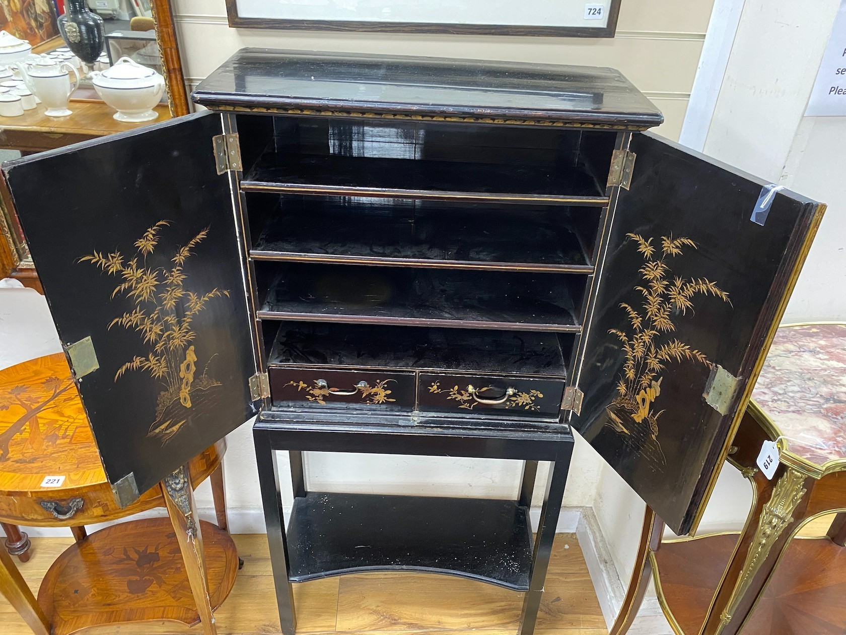 A chinoiserie lacquered two door side cabinet on later stand, width 64cm, depth 27cm, height 130cm